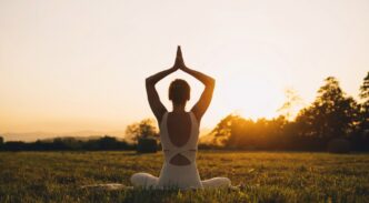 Mujer joven practicando yoga en la naturaleza.