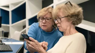 Dos señoras aprenden a utilizar un smartphone durante los talleres Competencias Digitales +60
